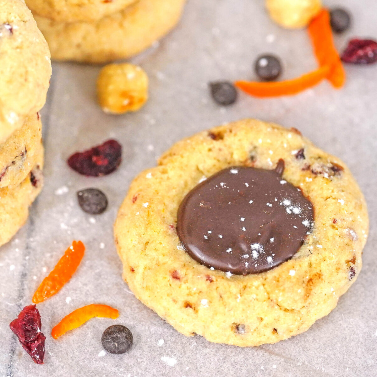 cranberry, hazelnut thumbprint cookies filled with creamy chocolate ganache
