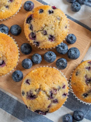 Blueberry Muffin Recipe - blueberry muffins on a board