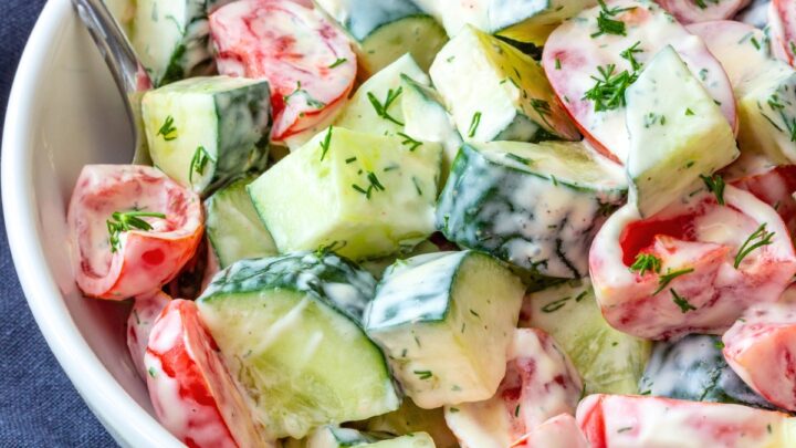 Tomato Cucumber Salad with Creamy Dill Dressing in a white bowl