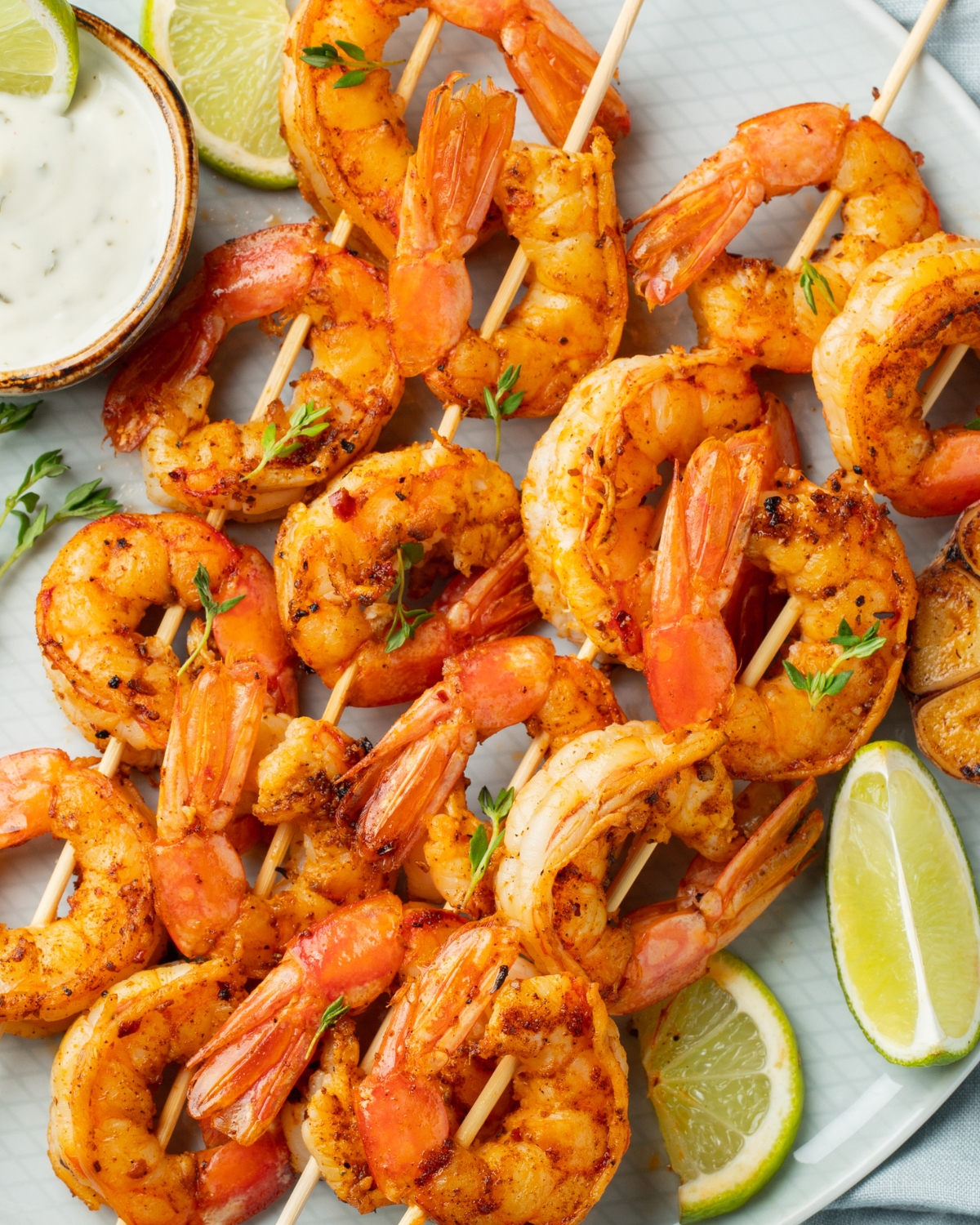 a plate of grilled shrimp skewers with citrus and garlic marinade