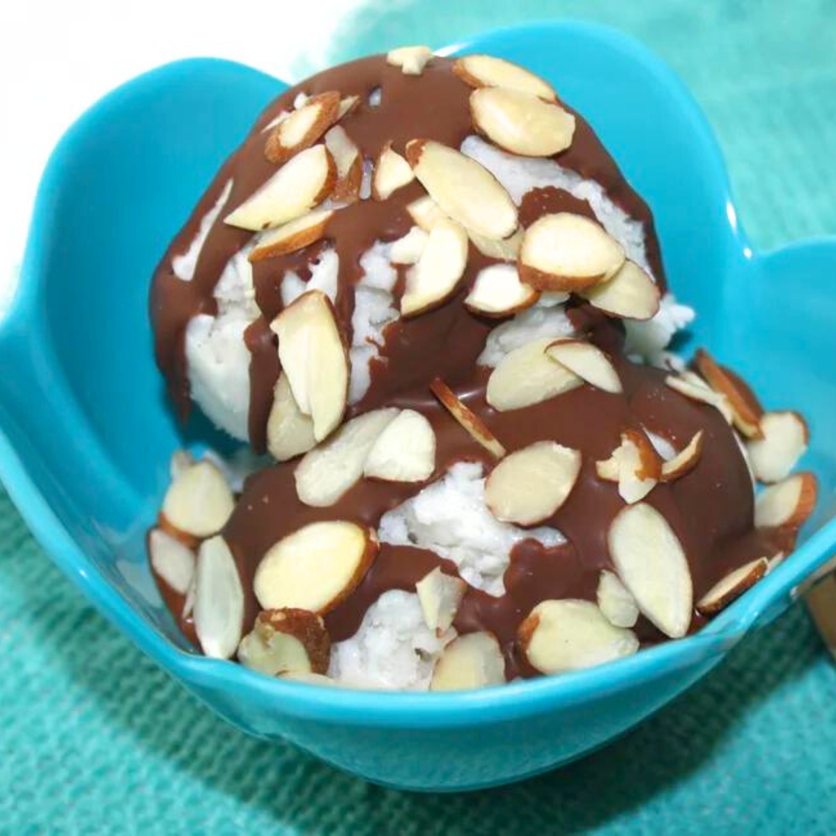 almond joy ice cream - a bowl of ice cream with chocolate and almonds