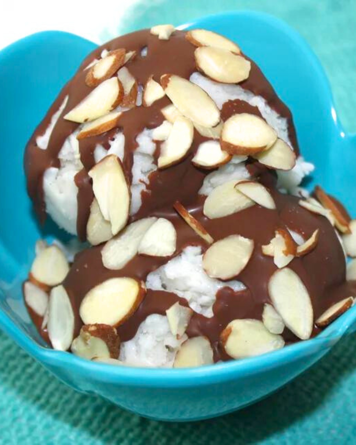 almond joy ice cream - a bowl of ice cream with chocolate and almonds