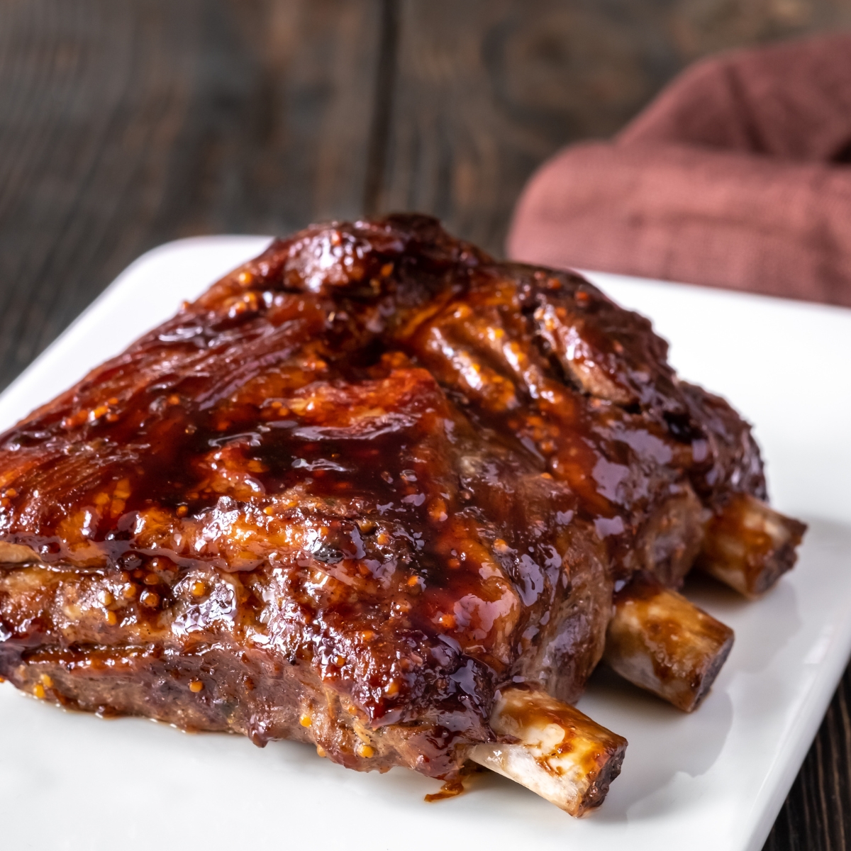 pork ribs with BBQ sauce on a white plate