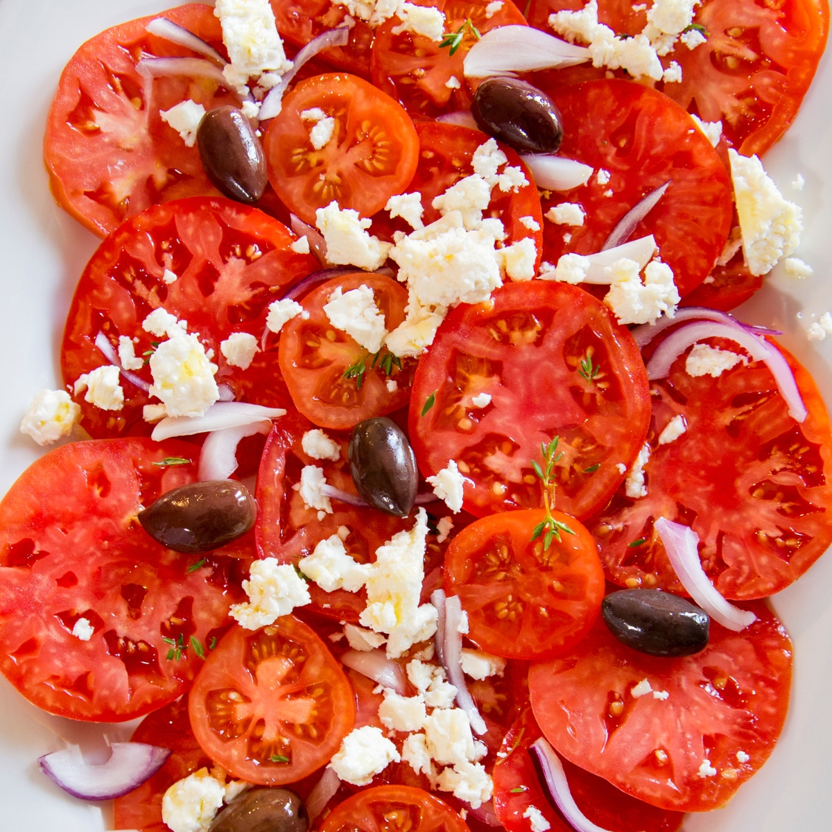 ripe tomato salad with feta cheese, olives and red onions