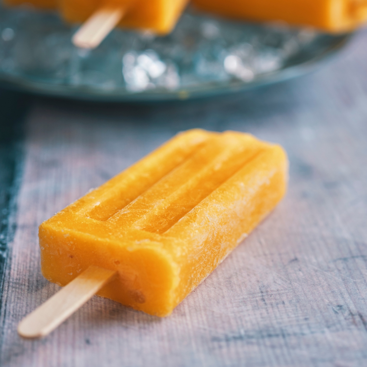 a mango popsicle on a plate