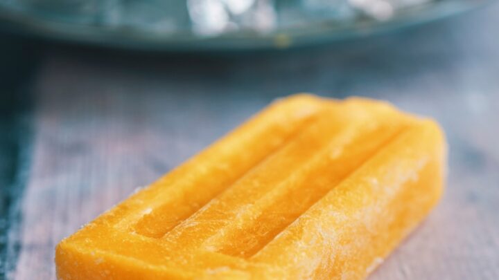 a mango popsicle on a plate