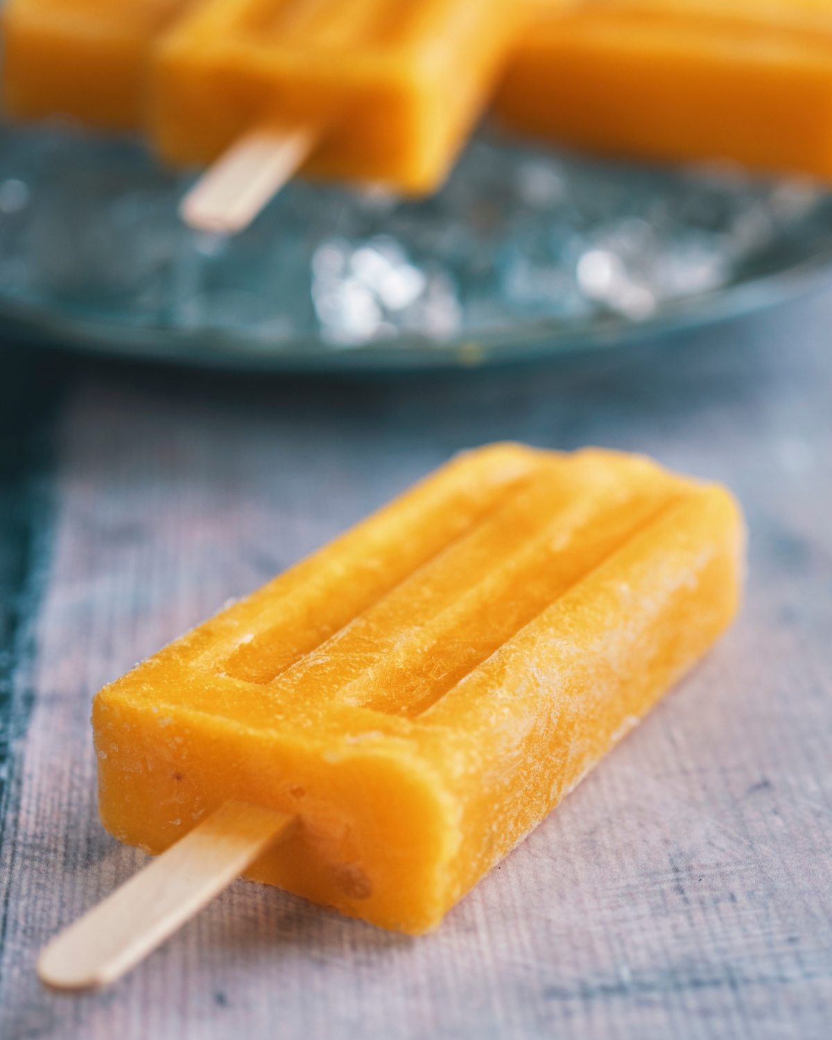 a mango popsicle on a plate