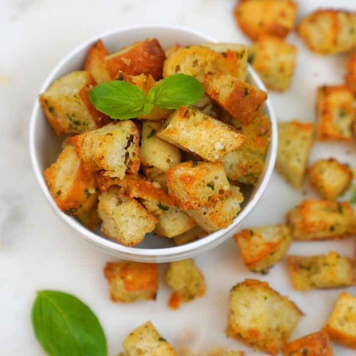 Parmesan Basil Croutons in a white bowl