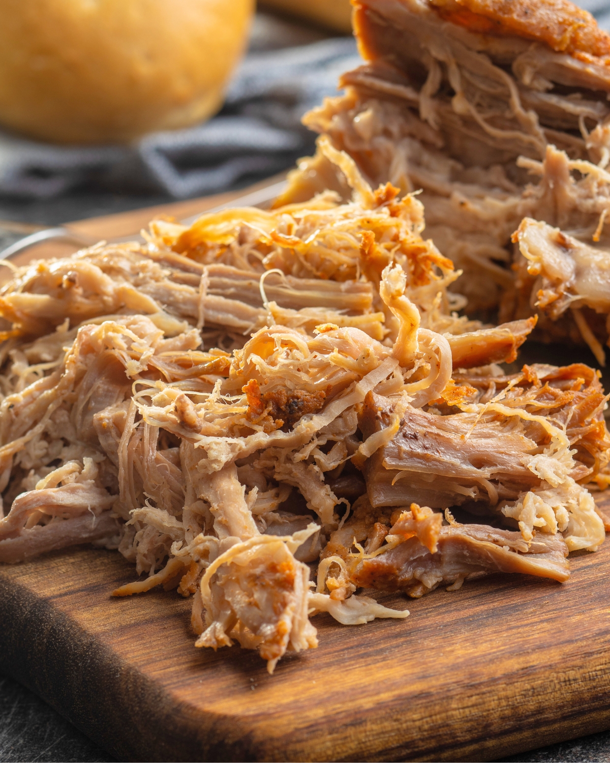 slow cooker pulled pork on a wooden board