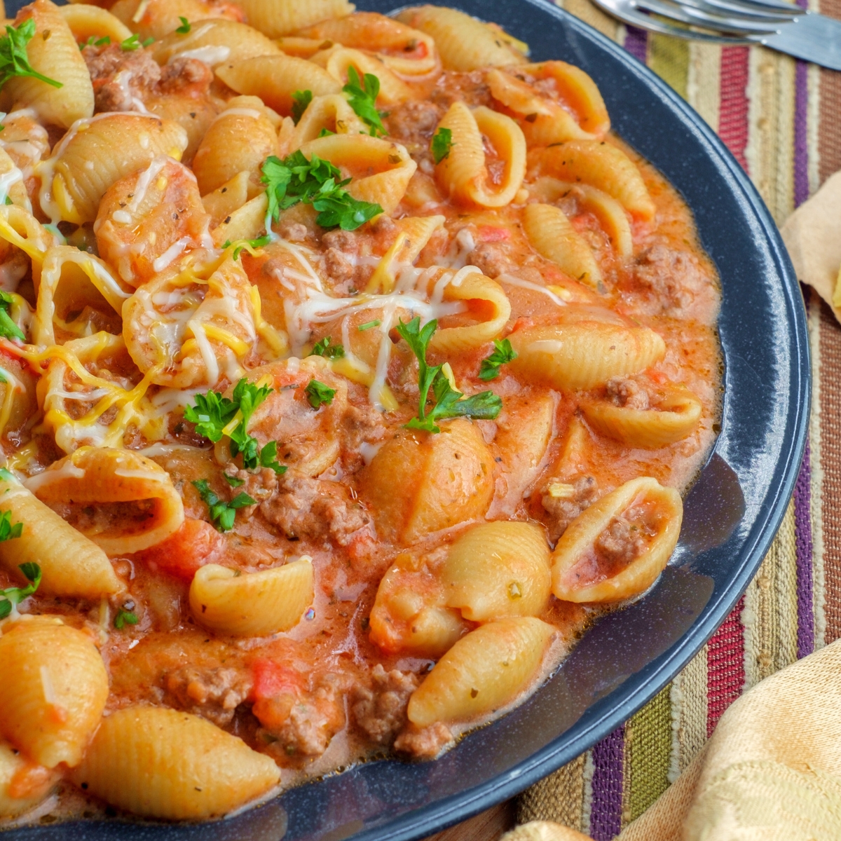 Creamy beef and shells in a blue bowl