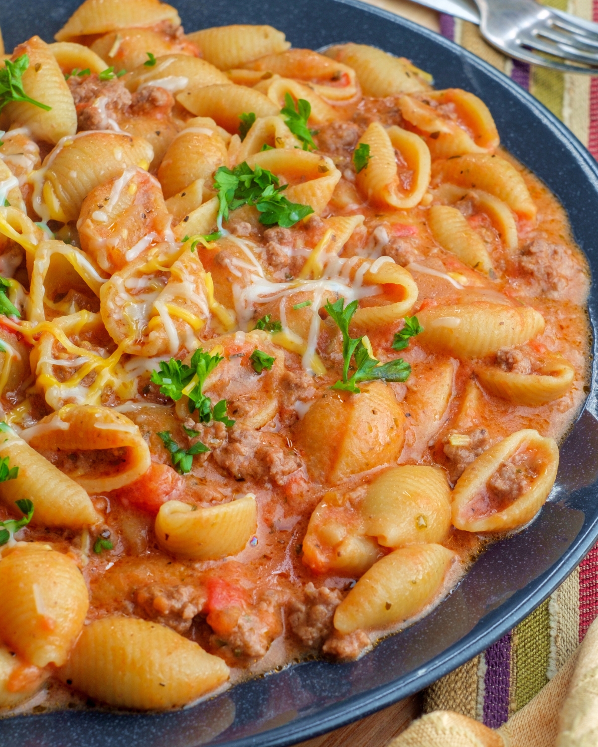 Creamy beef and shells in a blue bowl