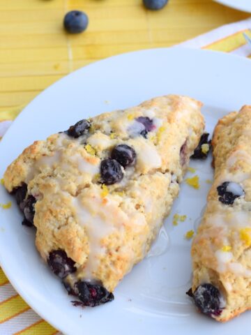 Blueberry Lemon Scones with Lemon Icing on a white plate