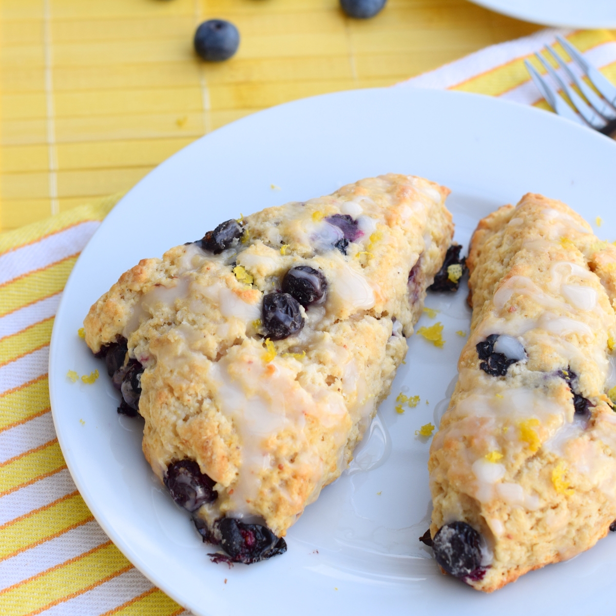 Blueberry Lemon Scones with Lemon Icing on a white plate