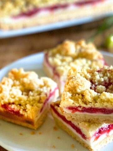 cherry cheesecake bars on a white plate