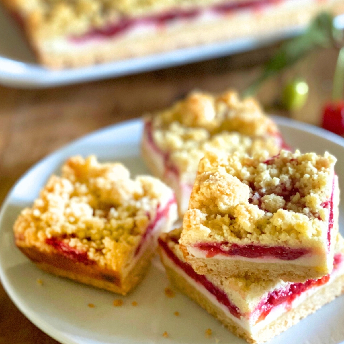 cherry cheesecake bars on a white plate