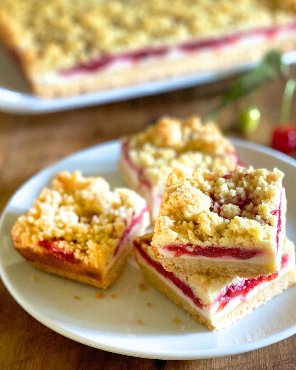 cherry cheesecake bars on a white plate