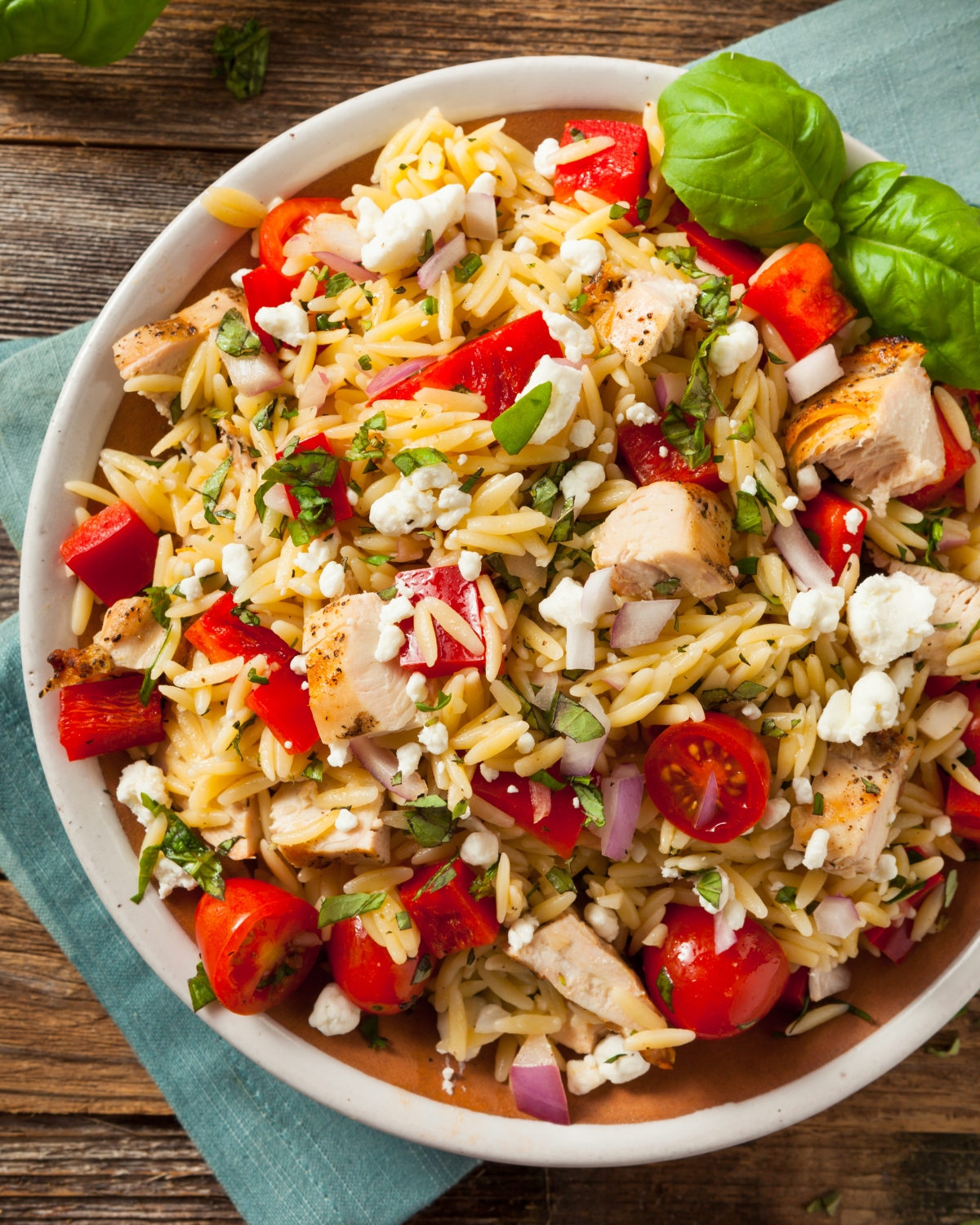 Chicken orzo salad in a white bowl