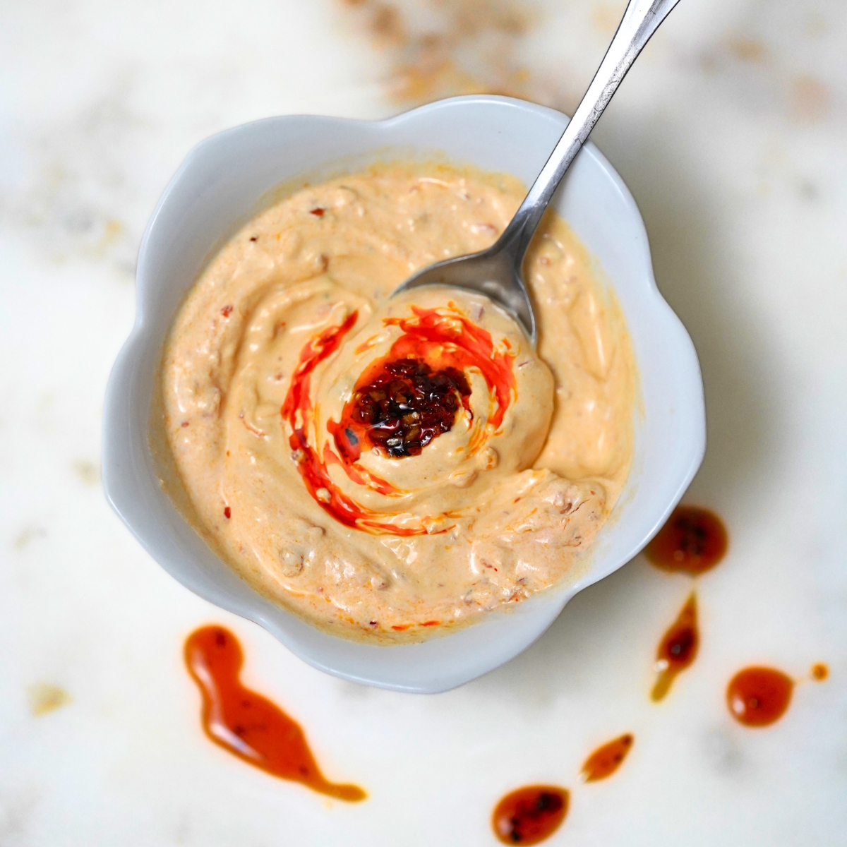 chili crunch sour cream taco sauce in a white bowl