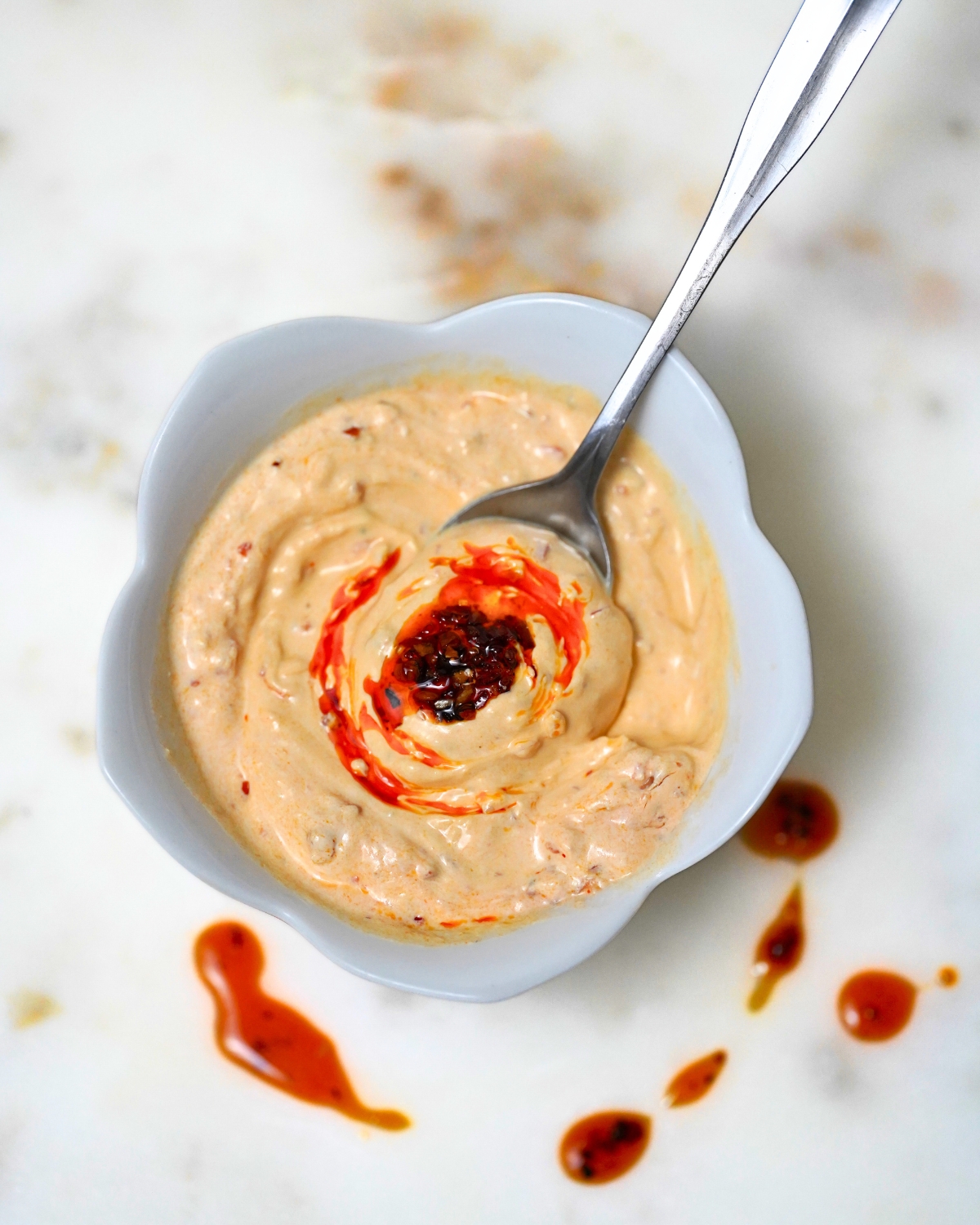 sauce for tacos - chili crunch sour cream sauce in a white bowl