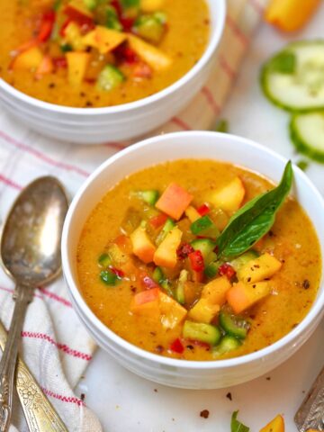 refreshing peach gazpacho in a white bowl