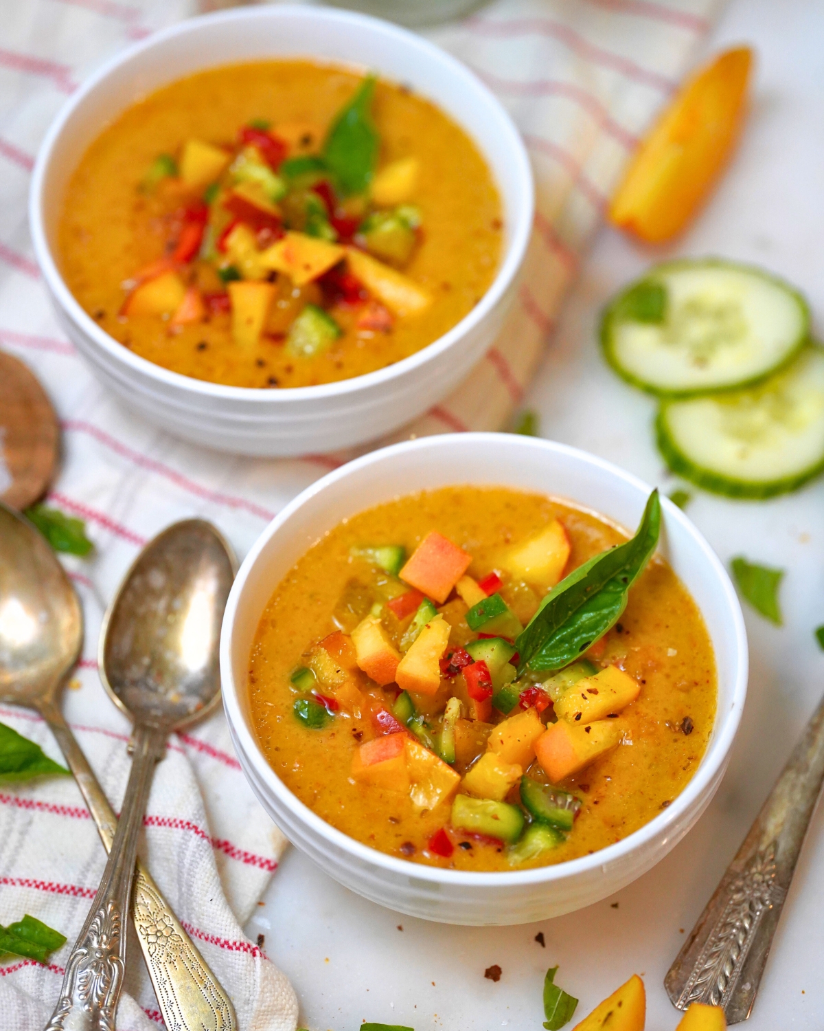 refreshing peach gazpacho in a white bowl