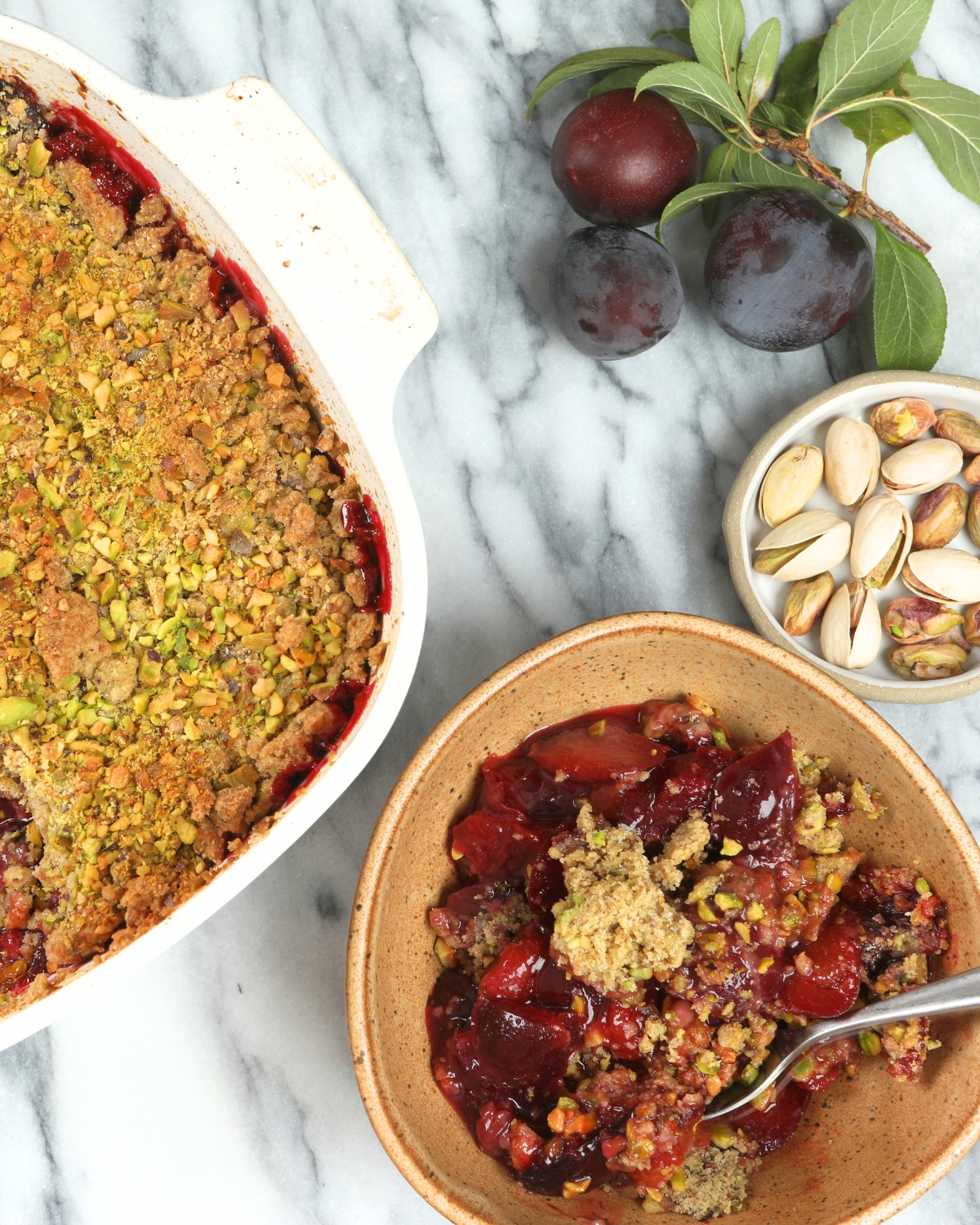 Plum Crisp with Pistachio Oat Crumble in a bowl 