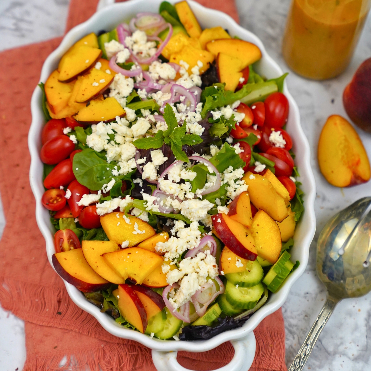 fresh summer peach salad in a white bowl