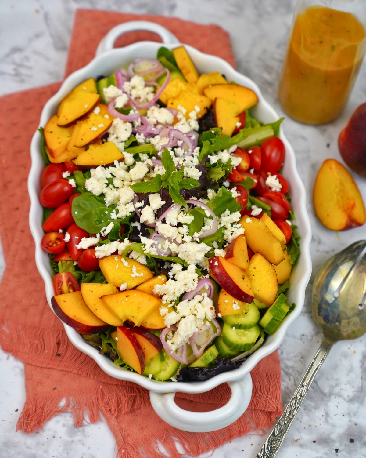 fresh summer peach salad in a white bowl