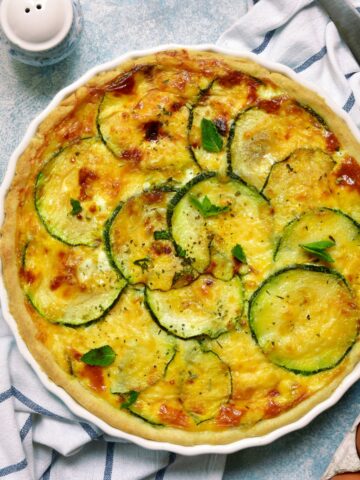 zucchini quiche in a white pie pan