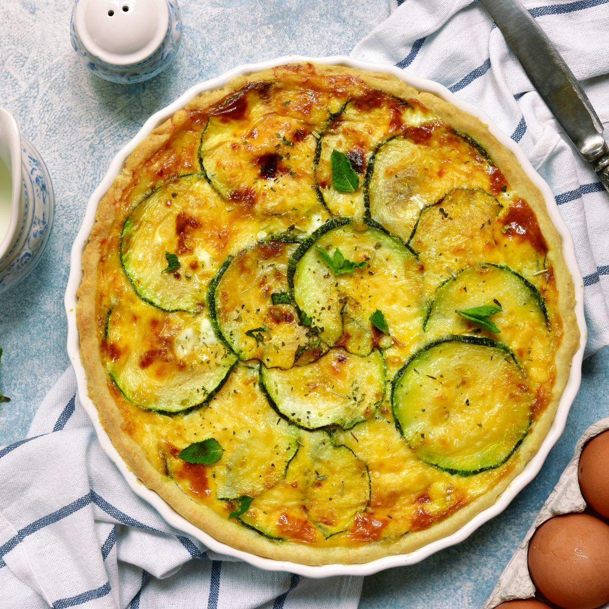 zucchini quiche in a white pie pan