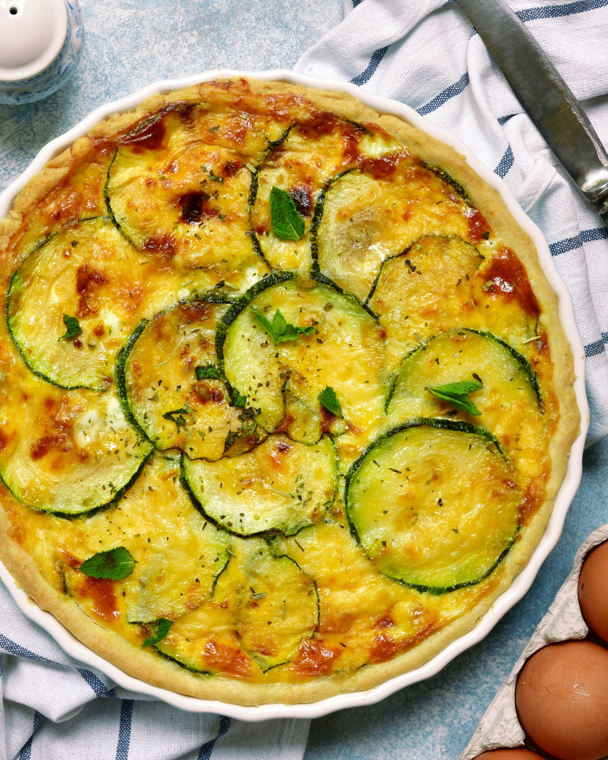 zucchini quiche in a white pie pan