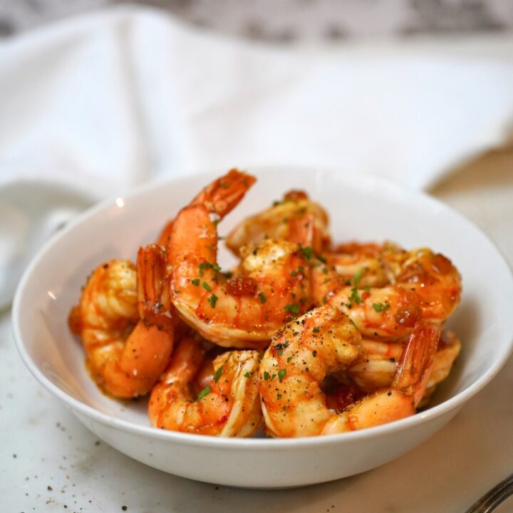 apricot glazed shrimp in a white bowl