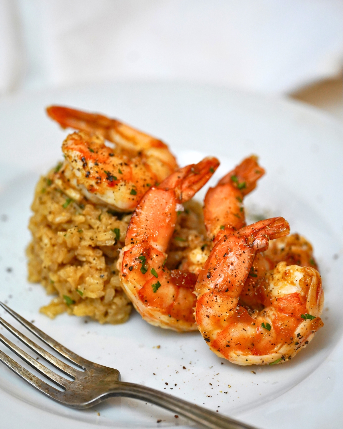 apricot glazed shrimp on a white plate with a side of rice