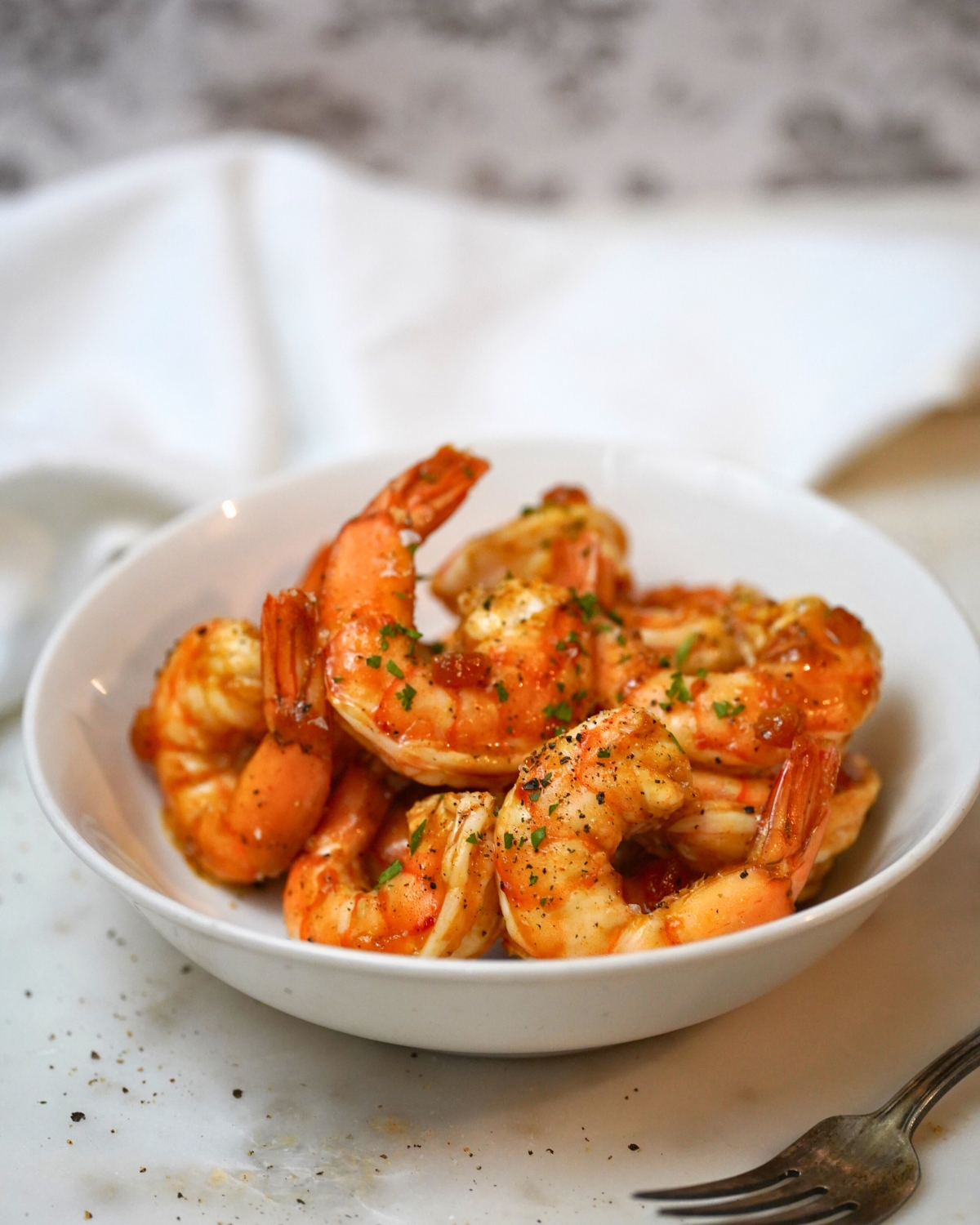 apricot glazed shrimp in a white bowl