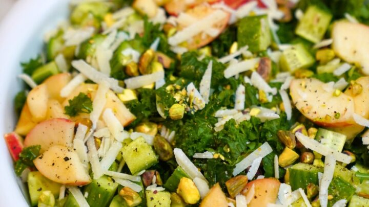 kale and apple salad in a white bowl