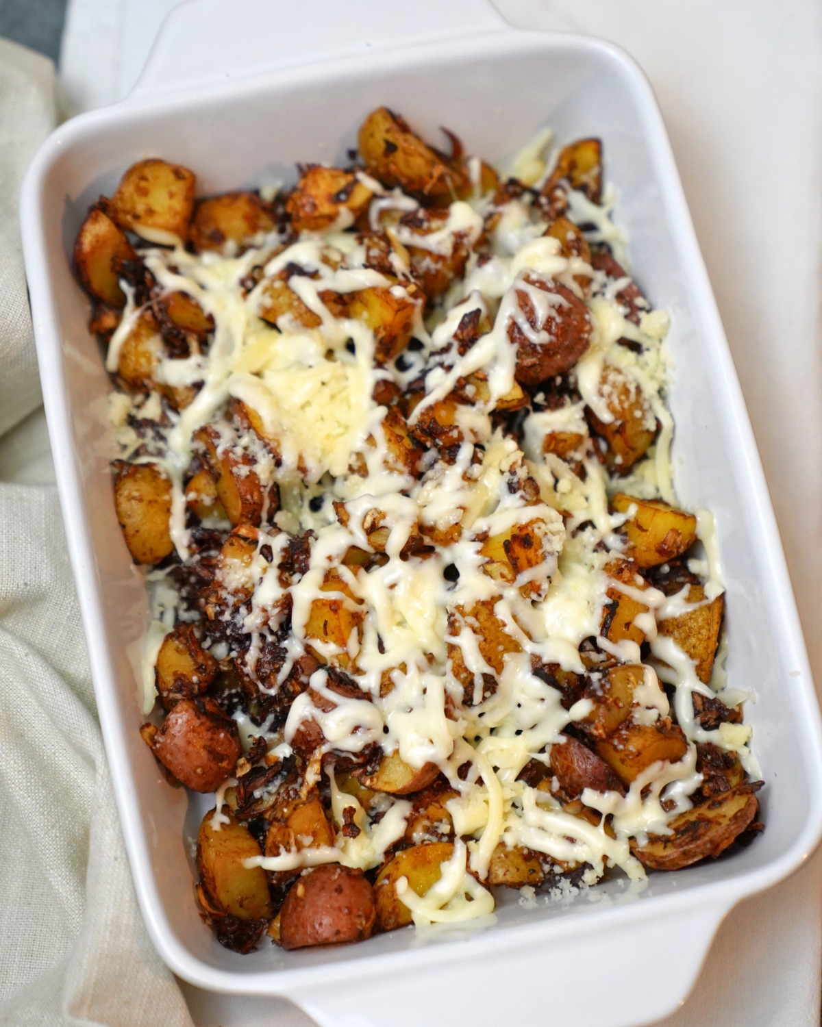 onion soup potatoes in a white baking dish