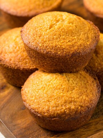 Pumpkin Corn Bread Muffins on a wooden board