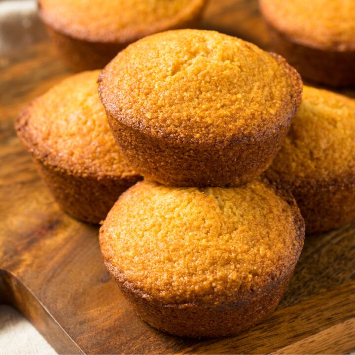 Pumpkin Corn Bread Muffins on a wooden board