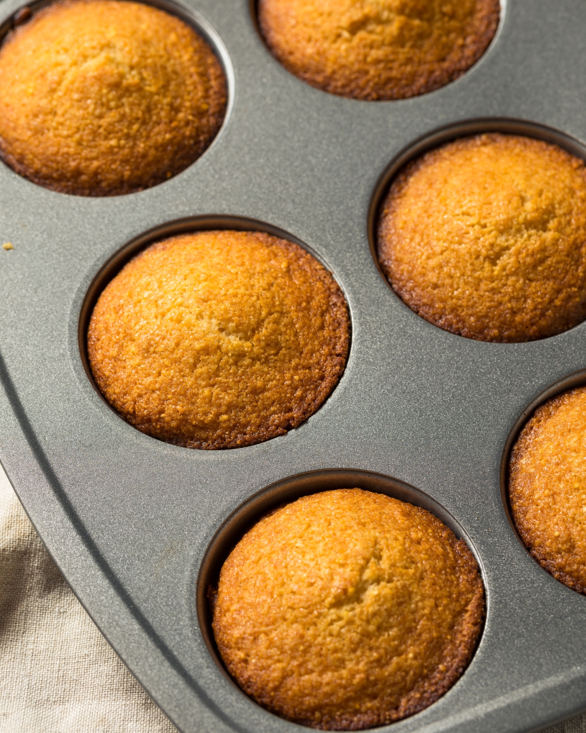 Pumpkin Corn Bread Muffins in a muffin tin