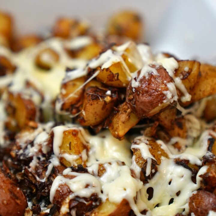 close up of onion soup potatoes in a white baking dish