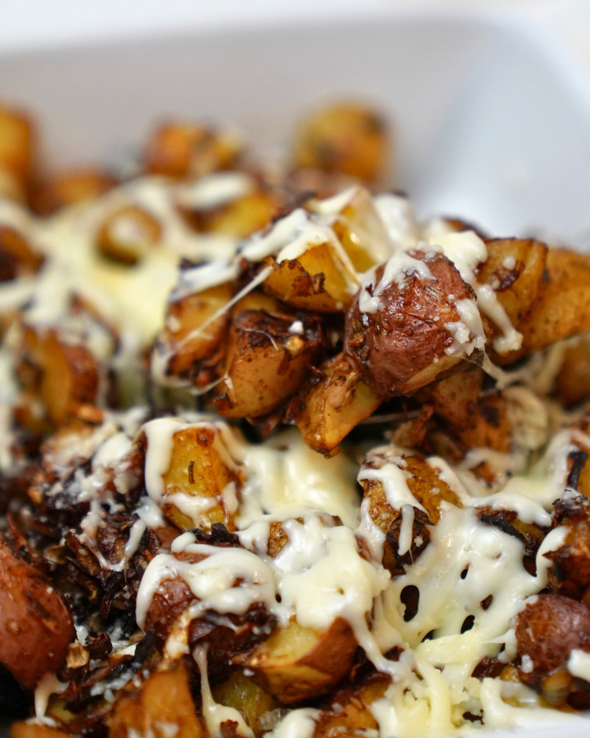 close up of onion soup potatoes in a white baking dish