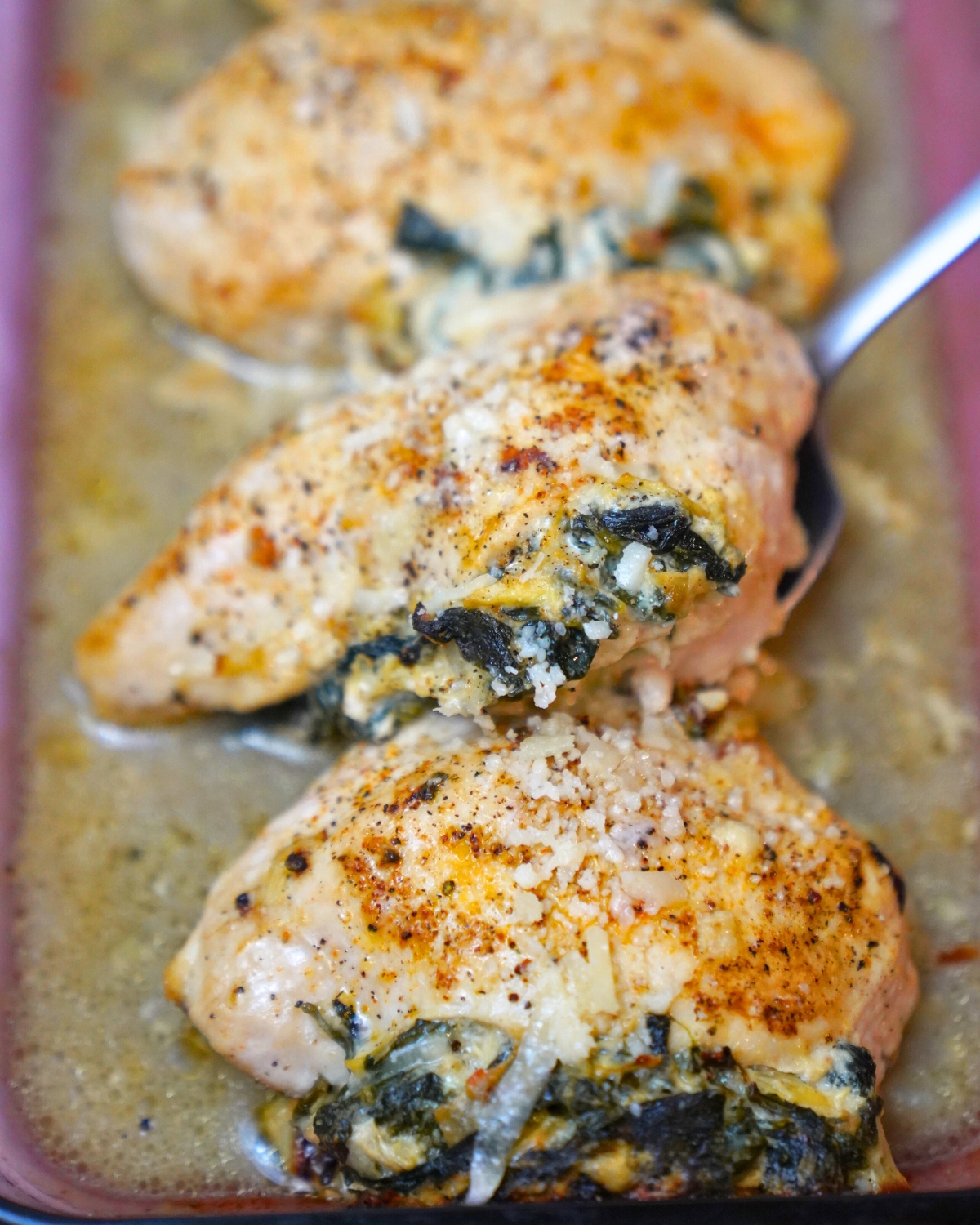 Spinach Artichoke Stuffed Chicken in a baking dish